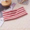 Detailed close-up shot of a colorful striped knitted wide headband for sports and yoga. - Red White