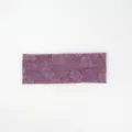 Detailed view of the retro purple knitted wide headband featuring an elegant rose floral pattern. - Purple