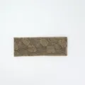 Detailed close-up view of the vintage floral knit headband, showing exquisite rose jacquard texture. - Camel