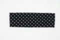 Closeup view of the black and white polka dot knitted wide headband texture and details. - Black Polka Dot