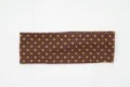 Detailed view of brown polka dot wide knit headband, elastic fabric for women daily wear. - Coffee Polka Dot