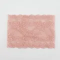 Wide pink lace fabric detail showing the delicate floral hollow pattern and scalloped edge. - Pink