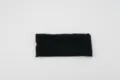 Close-up detail of black elastic sports headband, thick wide fabric, solid color hair accessory - Black