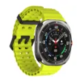 Bright yellow perforated silicone smartwatch strap replacement for sports and daily wear detail. - Silver Clasp / Star
