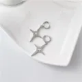 Silver four-pointed star crystal hoop earrings detailed close-up shot showing sparkling zircon design. - White Gold Hoops with Rhinestones