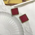 Red square textured earrings detail view, showing exquisite gold twisted border design. - Square Retro Red