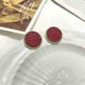 Exquisite round earrings featuring a red textured leather center and gold twisted rope edge detail. - Round Retro Red