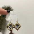 Elegant geometric square earrings with dark center stones and sparkly crystal pavé accents. - Sapphire Blue