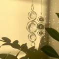 Minimalist crystal suncatcher pendant with geometric irregular gold rings and sparkling rainbow light. - Five Irregular Hoops / Gold
