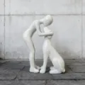 Nordic creative resin sculpture ornament depicting a person interacting with a dog, detailed view. - White