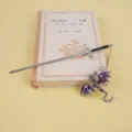 Detailed view of alloy sword bookmark with purple dragon pendant, perfect fantasy bookworm gift. - Purple