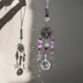 Crystal suncatcher detail with celestial sun moon star motifs and purple amethyst beads. - Purple Sun Goddess