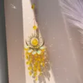 Crystal suncatcher hanging ornament with sun and moon motif and yellow beads for home decor. - Flame Moon Yellow