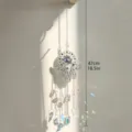 Evil eye hamsa suncatcher detail shot with shimmering crystal prisms and metal hanging chain. - Crystal Moon