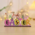 Close-up detail of the wooden Easter rabbit ornament with colorful eggs and festive text. - HAPPY EASTER Lettering
