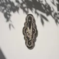 Detailed view of gothic style wooden wall plaque featuring intricate skull carving and stars. - Style 7