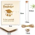 Detail view of graduation wooden gift set featuring engraved plaque, glass tube, and twine. - Graduation Cap