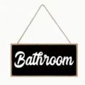 Rustic wooden bathroom hanging sign with rope, black and white wall decor detail view. - 20x10 / J20X10-129-3