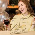 Detailed view of the personalized wooden number guest book ornament for party table decor. - 25