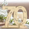 Wooden number 70 display stand detail showing custom engraved names and anniversary years for party. - 70