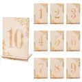 Detailed close-up of laser-engraved wooden table number cards with stands and leaf patterns. - 10 Pieces