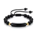 Schwarzes Perlenarmband mit Goldkugeln und gebogenem Tubusanhänger verstellbares Seil. - Obsidian Armband