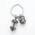 Detailed view of the metal dumbbell and kettlebell sports keychain, gym fitness accessory. - Black