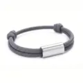 Detailed close-up of a grey handmade braided paracord bracelet with a polished stainless steel tube. - 2cm Square Tube Paracord Style / Gray Cord Silver Accessories
