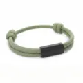 Detailed view of the green woven paracord bracelet featuring a sleek black stainless steel tube. - 2cm Square Tube Paracord Style / Green Cord Black Accessories
