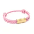 Closeup of pink paracord bracelet with gold stainless steel tube detail and adjustable design. - 2cm Square Tube Paracord Style / Pink Cord Gold Accessories