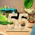 Wooden number 55 sign detail showing personalized laser engraved names and memorial years. - 55