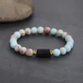 Detailed close-up shot of beaded bracelet featuring natural stone beads and black center accent. - Tourmaline Sodalite Beaded Bracelet / 8MM/1 Piece