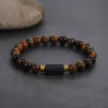 Close-up of a natural tiger eye and black stone beaded bracelet with metallic spacers. - Tourmaline Yellow Tiger Eye Beaded Bracelet / 8MM/1 Piece