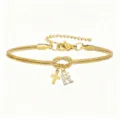 Bracciale serpente dorato con ciondolo lettera R e croce, gioiello elegante per donna. - Bracciale Nodo Concentrico Croce Strass Stile R / Oro