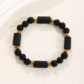 Black and gold beaded bracelet, obsidian cylindrical stones with metal spacers. - Tourmaline Obsidian Bracelet