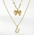 Collana doppia dorata con ciondolo a fiocco e lettera con strass, elegante e chic. - Stile a Doppio Strato con Lettera Iniziale U e Fiocco / Oro