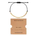 Adjustable black wax rope Morse code bracelet with gold beads and kraft display card. - Morse Code Style A / Gold