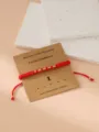 Red braided Morse code number 1 bracelet with gold beads and handmade craft card display. - Morse Code 1 Red Flat Knot Cord Bracelet with Card