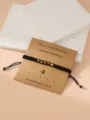 Black braided Morse code bracelet with gold beads and lucky number 4 design for daily wear. - Morse Code 4 Black Flat Knot Bracelet with Card