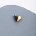 Close-up detail shot of stainless steel black and gold heart magnetic DIY jewelry charm component - Black and Gold