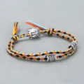 Handmade woven multi-color cotton rope bracelet featuring alloy Buddha head and carved beads detail. - Buddha Head Hand Rope F1 (Multicolor)