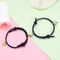 Detail view of matching couple magnetic heart braided bracelets with cute winged lock charms. - Magnetic Heart Pair / 1 Pair / Dark Blue