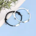 Detail shot of black and white matching magnetic couple bracelets with stainless steel tag. - Magnetic Heart Stainless Steel Bar Black and White Pair