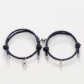 Close-up of matching couple bracelets with lock key charms and magnetic attraction design. - Key Lock Dark Blue Pair