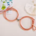 Couple magnetic heart braided rope bracelet set, matching pink love charm jewelry detail. - Elastic Heart Magnet Style / 1 Pair / Orange