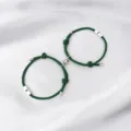 Detailed view of the magnetic sun and moon couple bracelets with green braided ropes. - Sun & Moon / 2-Piece Set / Dark Green