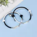 Close-up detail of magnetic couple heart bracelet, black white woven rope, stainless steel bar. - Magnetic Heart Stainless Steel Bar Black White Dual Color Pair