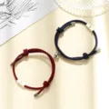 Details of red and blue braided couple magnetic bracelets with sun and moon charms pair. - Milan Cord Sun Moon Dark Blue and Wine Red Pair