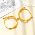 Sun and moon magnetic couple bracelet detailed view, matching braided charm wristband jewelry. - Milan Cord Sun Moon Orange Pair