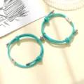 Close-up detail shot of couple magnetic matching braided rope bracelets in bright turquoise tone. - Milan Cord Sun Moon Lake Blue Pair